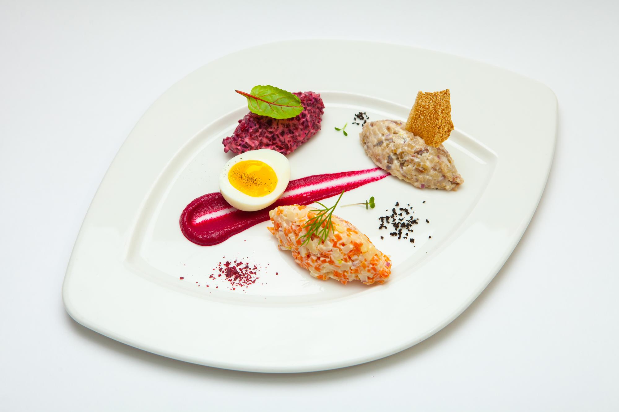 Wide view of a crafted plated dish in a studio